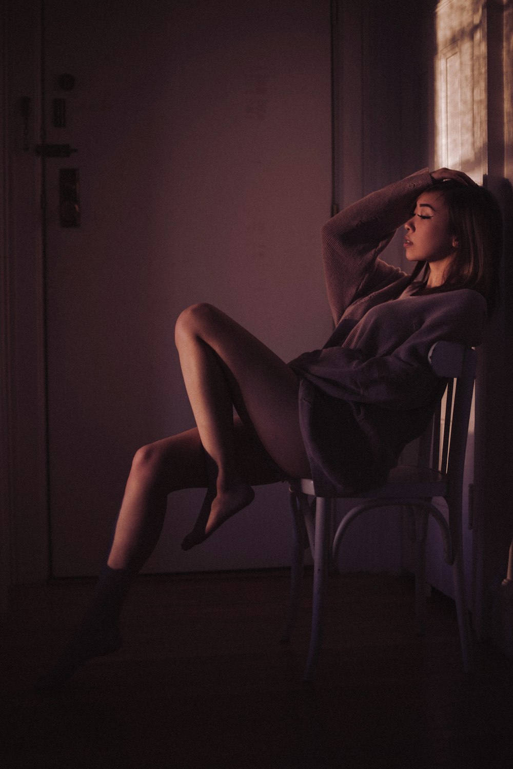 woman in purple robe sitting on chair