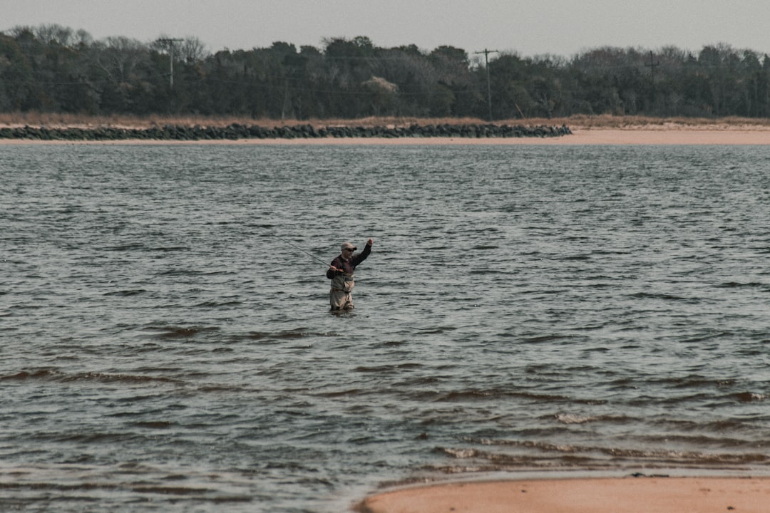 man in black shorts jumping on water during daytime