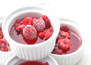 red raspberry on white ceramic bowl