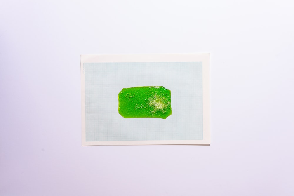 green crystal on white surface