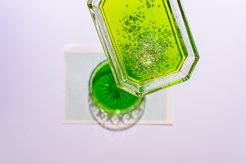 green and silver glass bottle