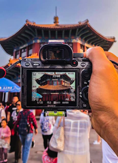 person holding black dslr camera