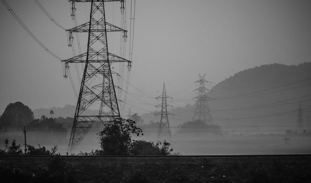 grayscale photo of electric towers