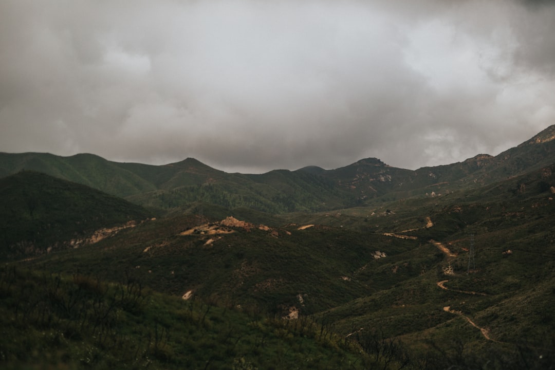 green and brown mountains under white clouds