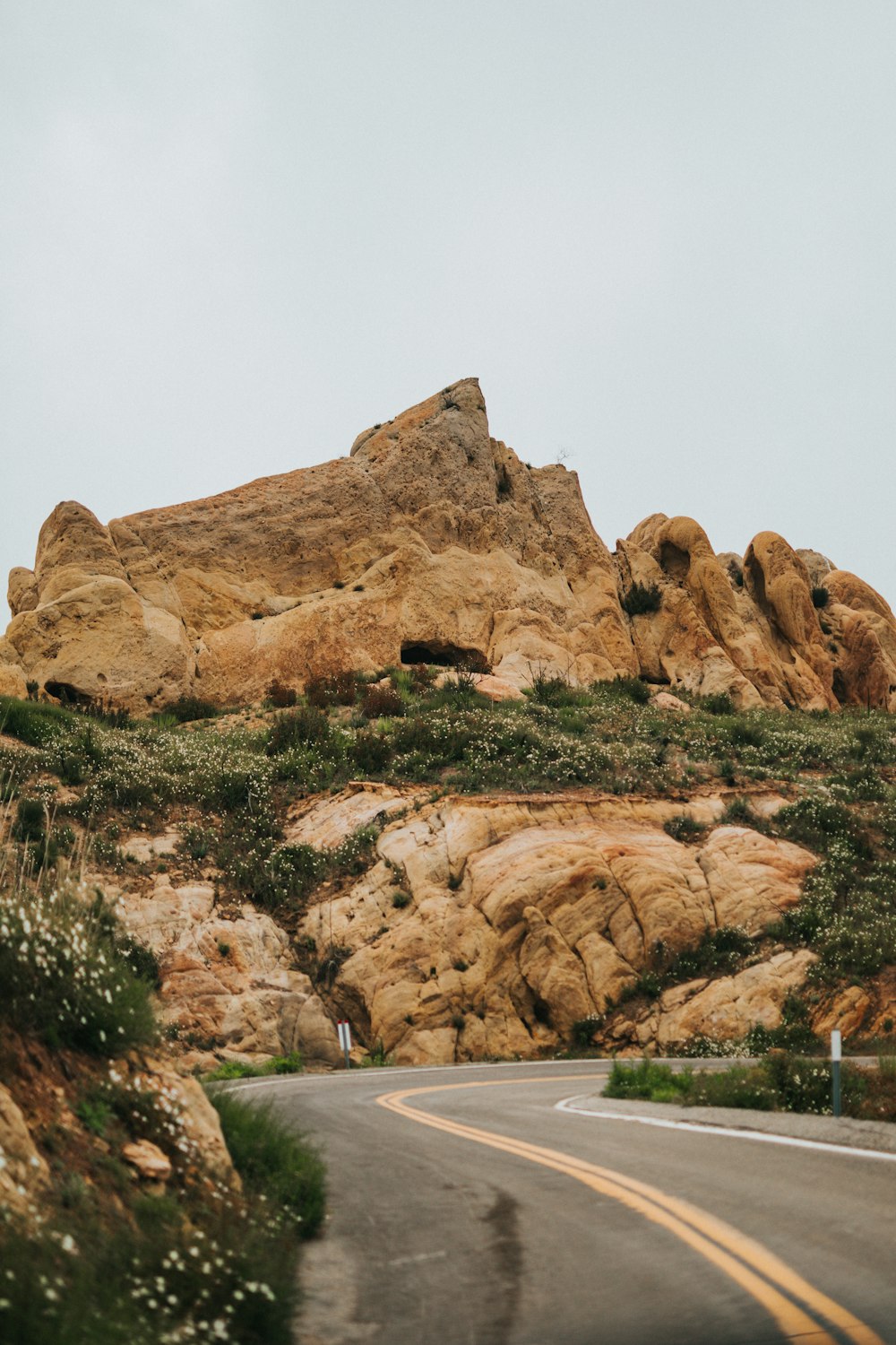 brown rock formation near body of water during daytime