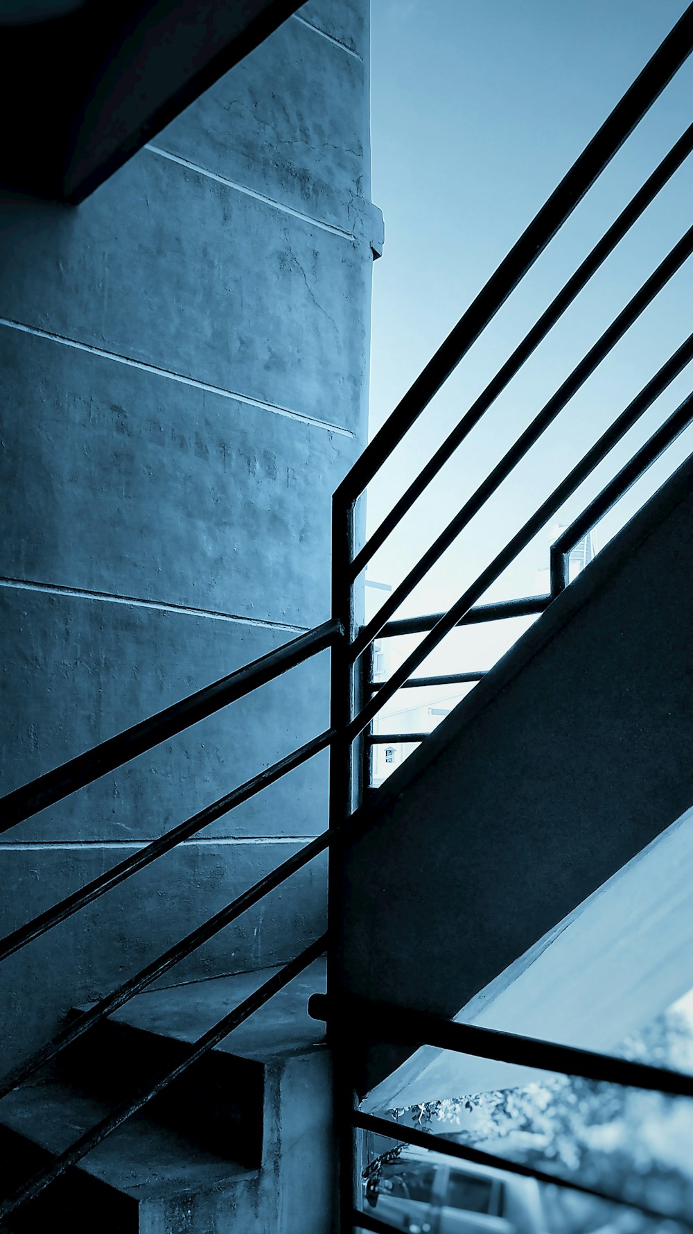 black metal staircase on gray concrete wall