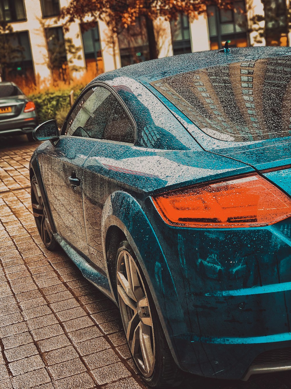 black and orange porsche 911 parked on sidewalk during daytime