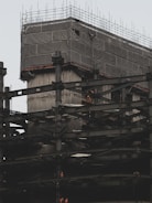 A bustling commercial building under construction showcasing steel framework and workers.