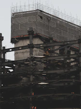 On-site photo showing construction workers actively building a structure.