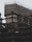 A commercial building under construction with workers installing steel beams.