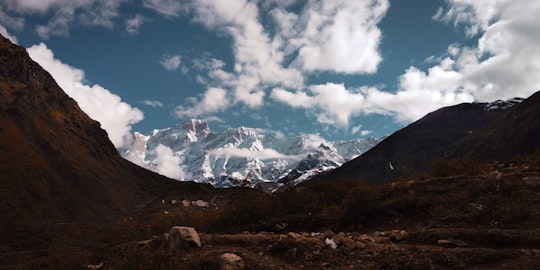 snow covered mountain under blue sky and white clouds during daytime in Kedarnath India