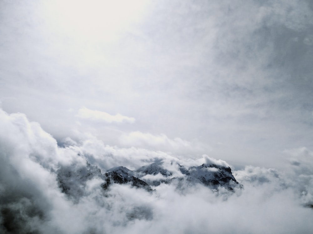 snow covered mountain under cloudy sky during daytime