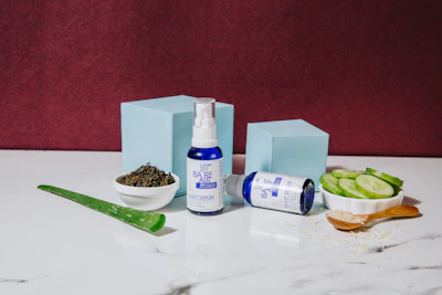 Elegant bottles of bio-stimulators and rejuvenating serums displayed on a sleek white surface.