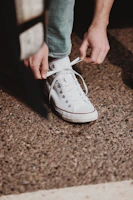 Close-up of hands tying running shoes, ready for the next challenge.