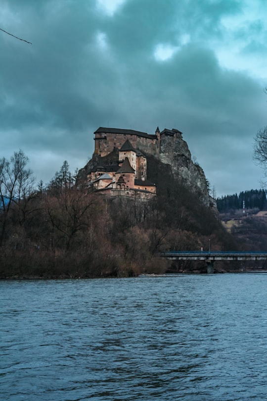 brown concrete building near body of water during daytime in Orava Castle Slovakia