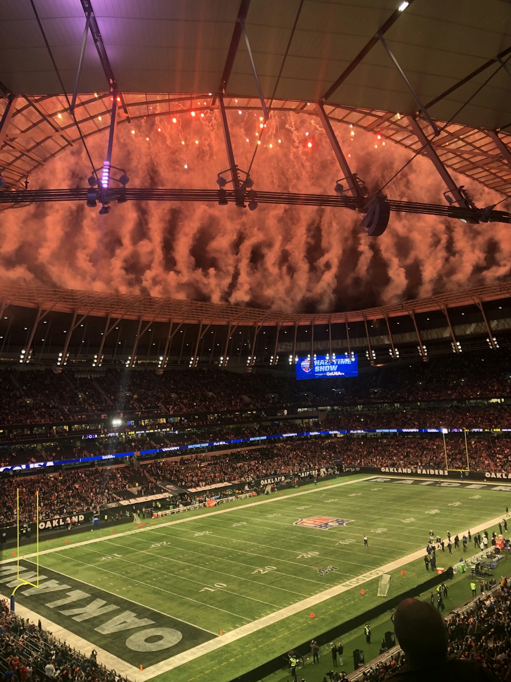 people watching football game during nighttime