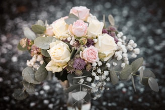 pink and yellow roses in clear glass vase