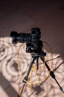 black dslr camera on black tripod