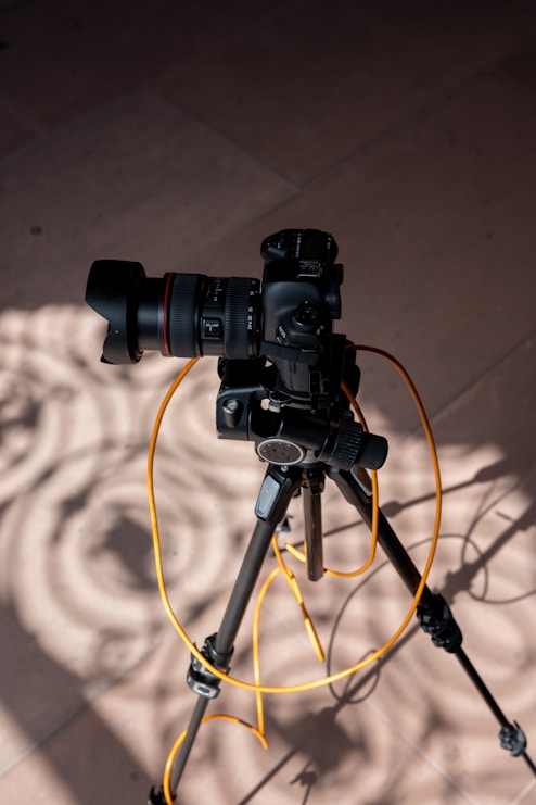 black dslr camera on black tripod