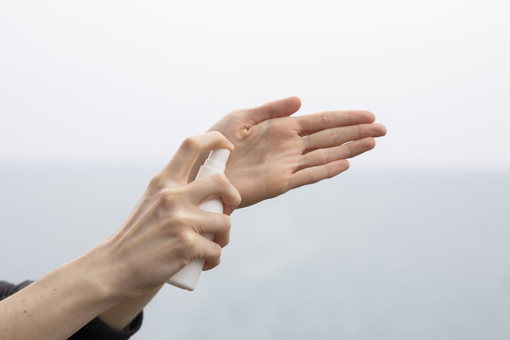 person doing hand sign during daytime