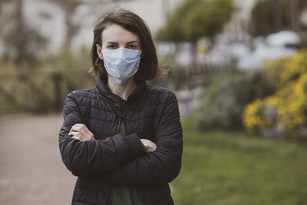 woman in black jacket wearing white mask