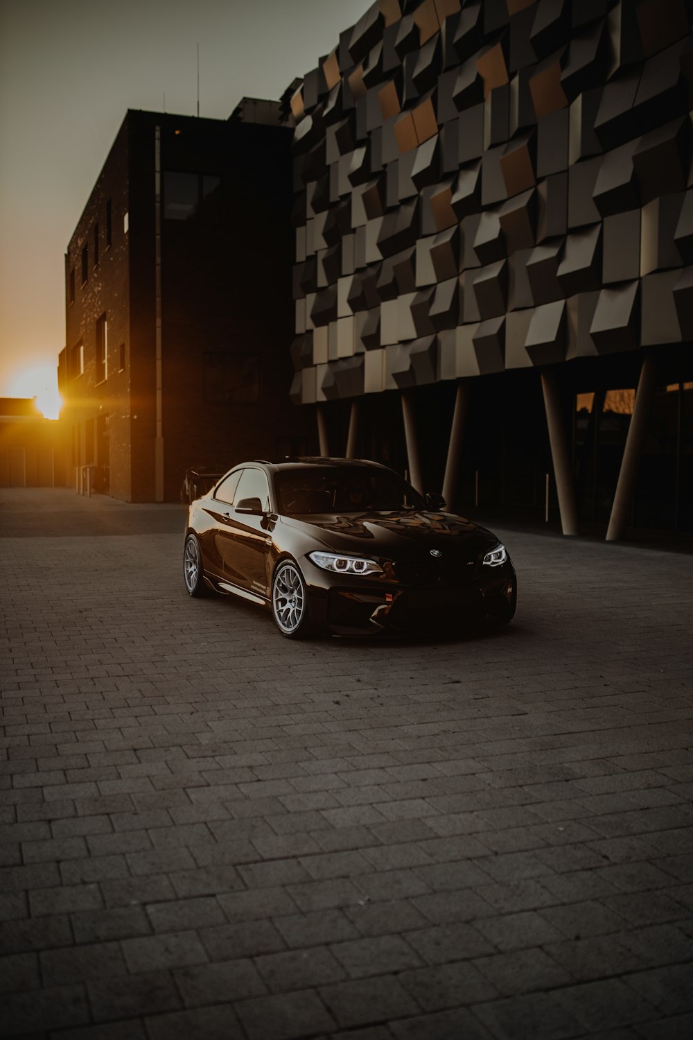 black bmw m 3 parked in front of building