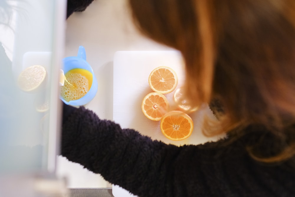 woman in black sweater with orange and blue round plastic toy