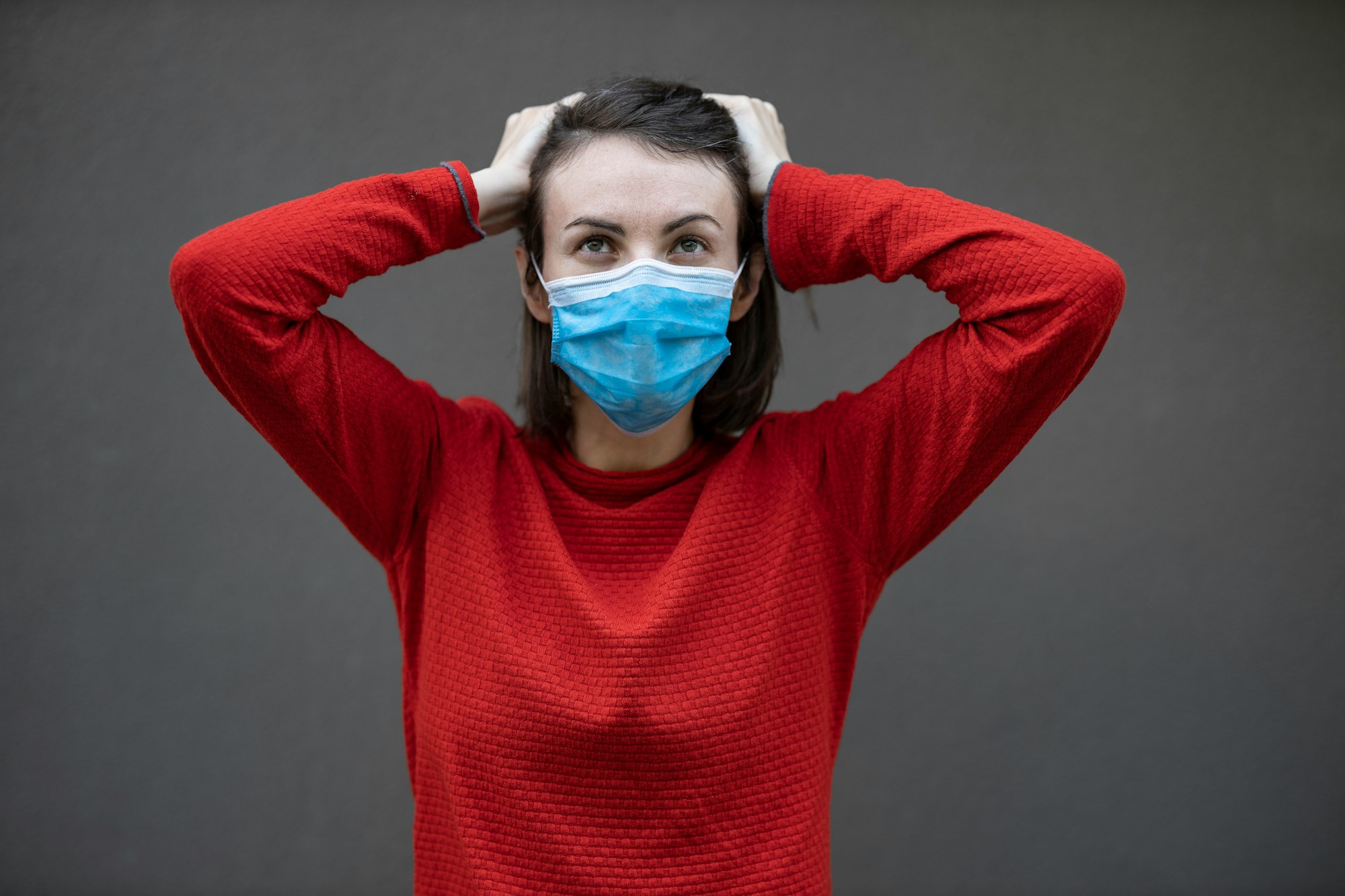 man in red sweater with face mask