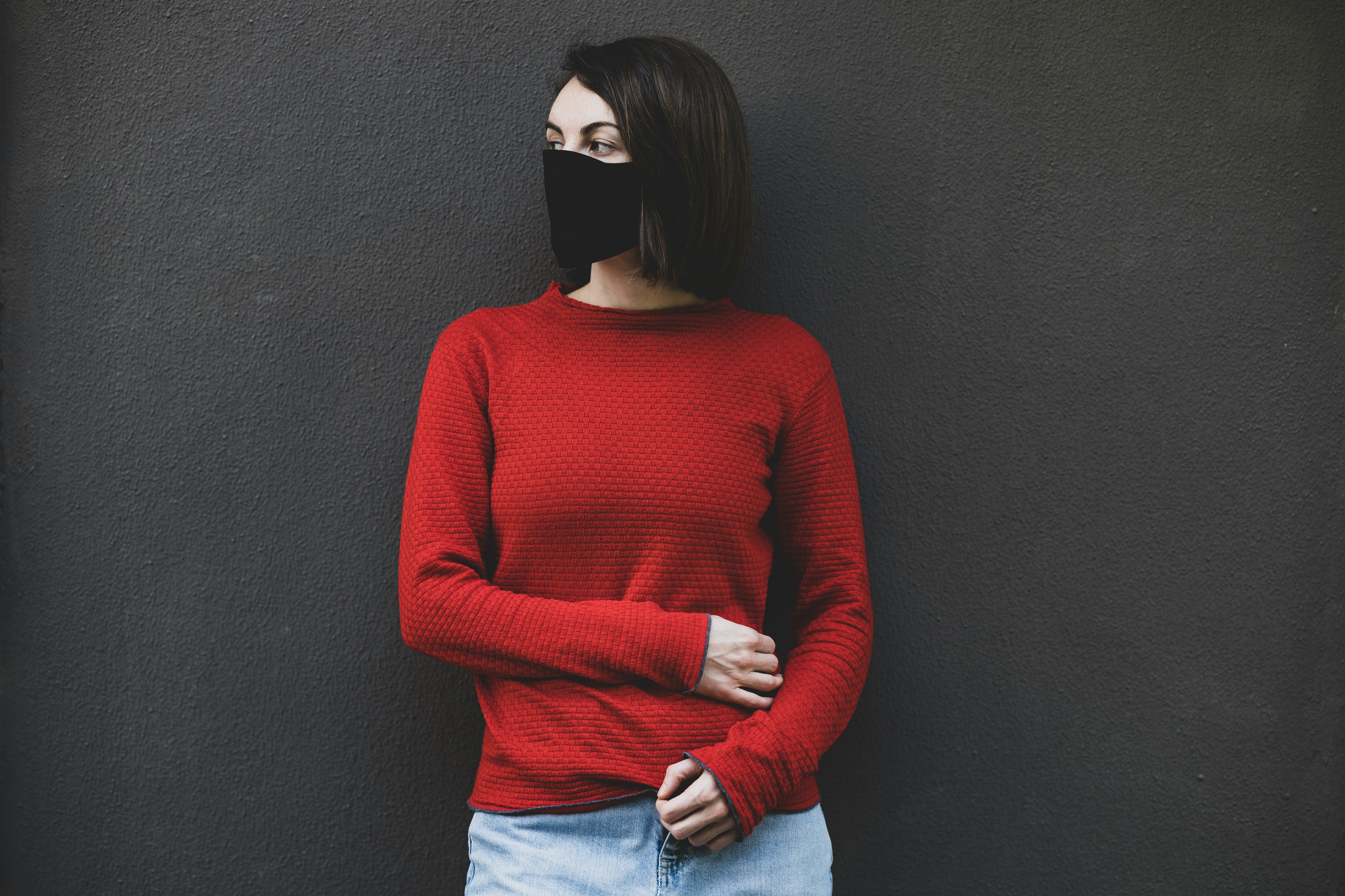 woman in red sweater and blue denim jeans