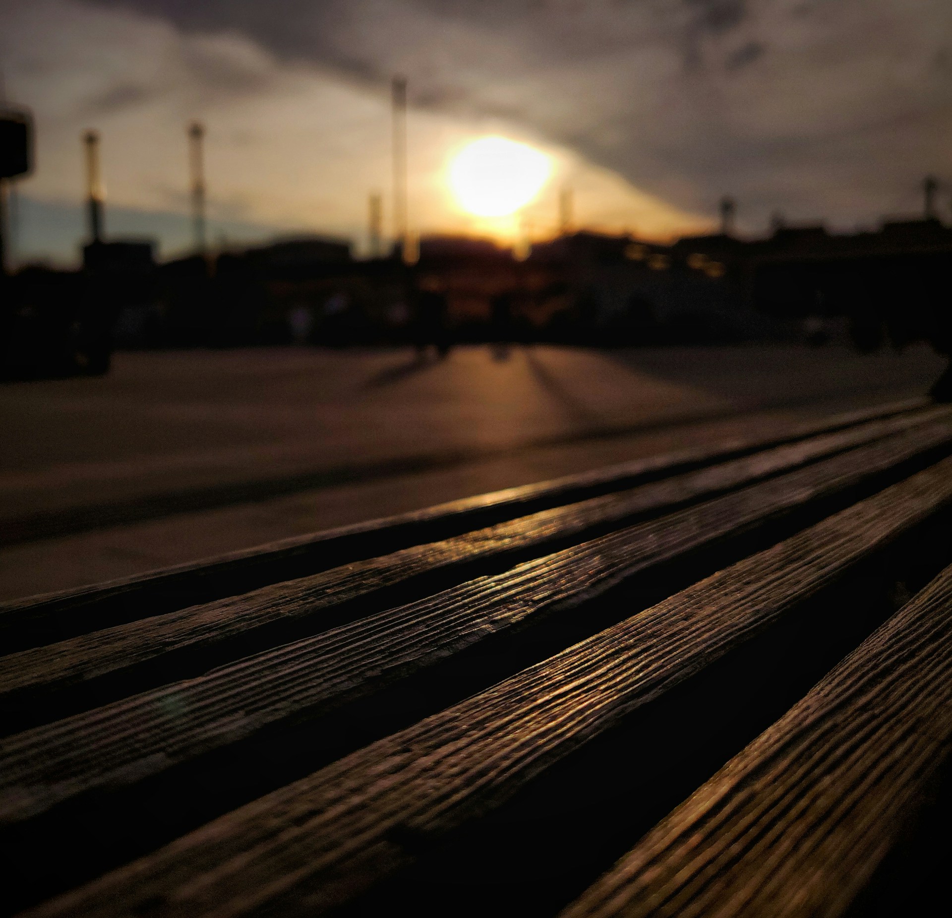 A serene sunset casting long shadows over a quiet studio filled with instruments and canvases, blending past and future creativity.