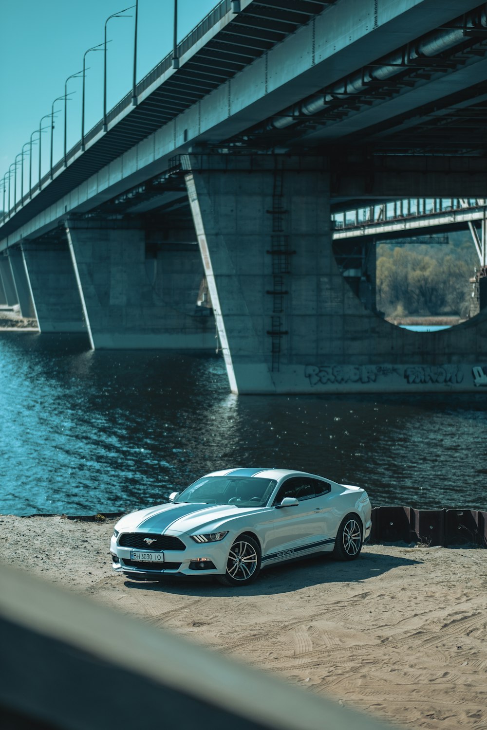 silver porsche 911 parked near bridge during daytime