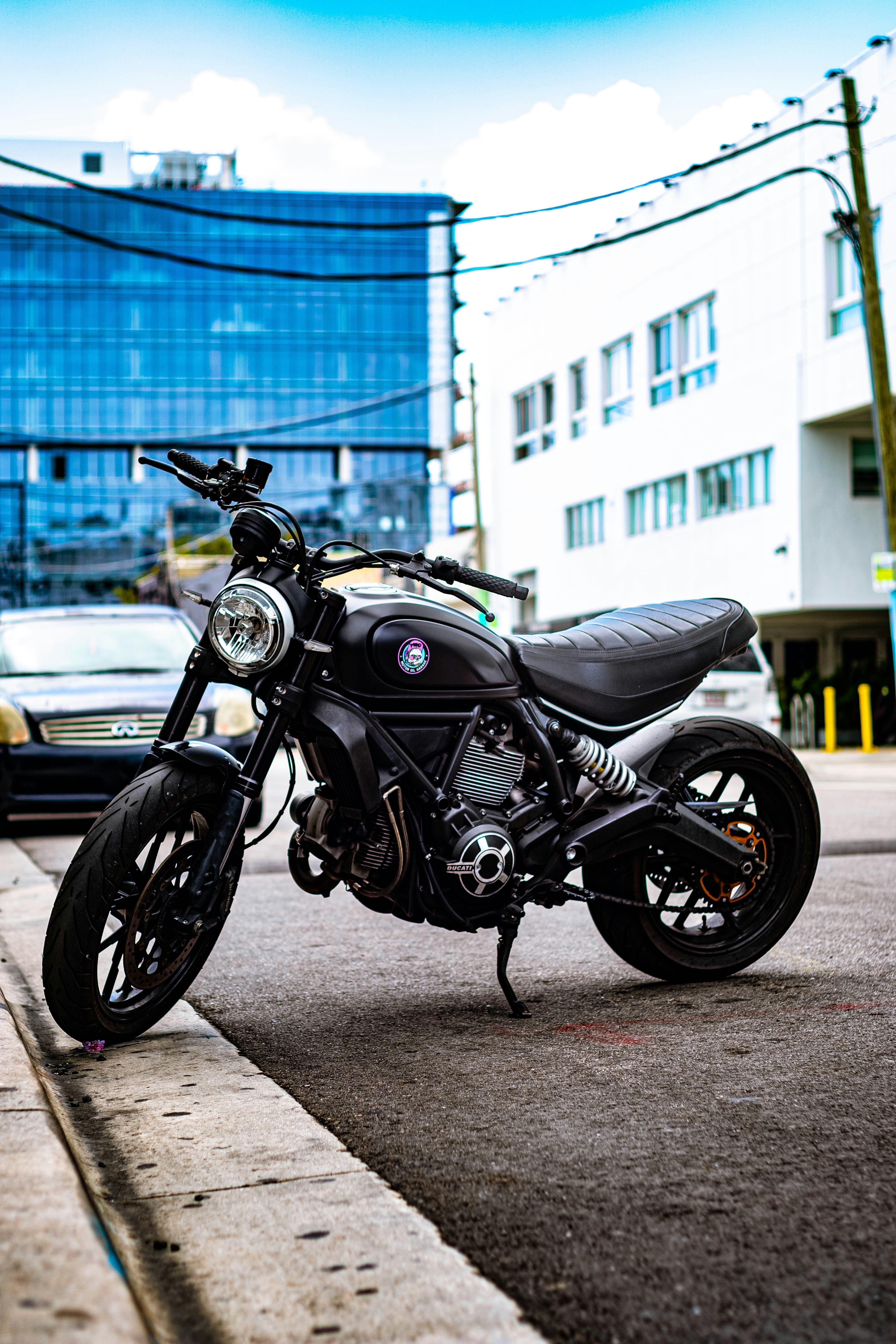 black and silver cruiser motorcycle parked on gray concrete road during daytime