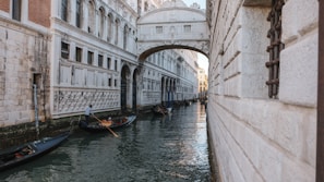 Historic canals of Venice with gondolas gliding under ancient bridges