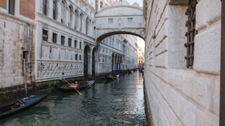 Historic canals of Venice with gondolas gliding under ancient bridges