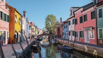 boat on river between houses during daytime