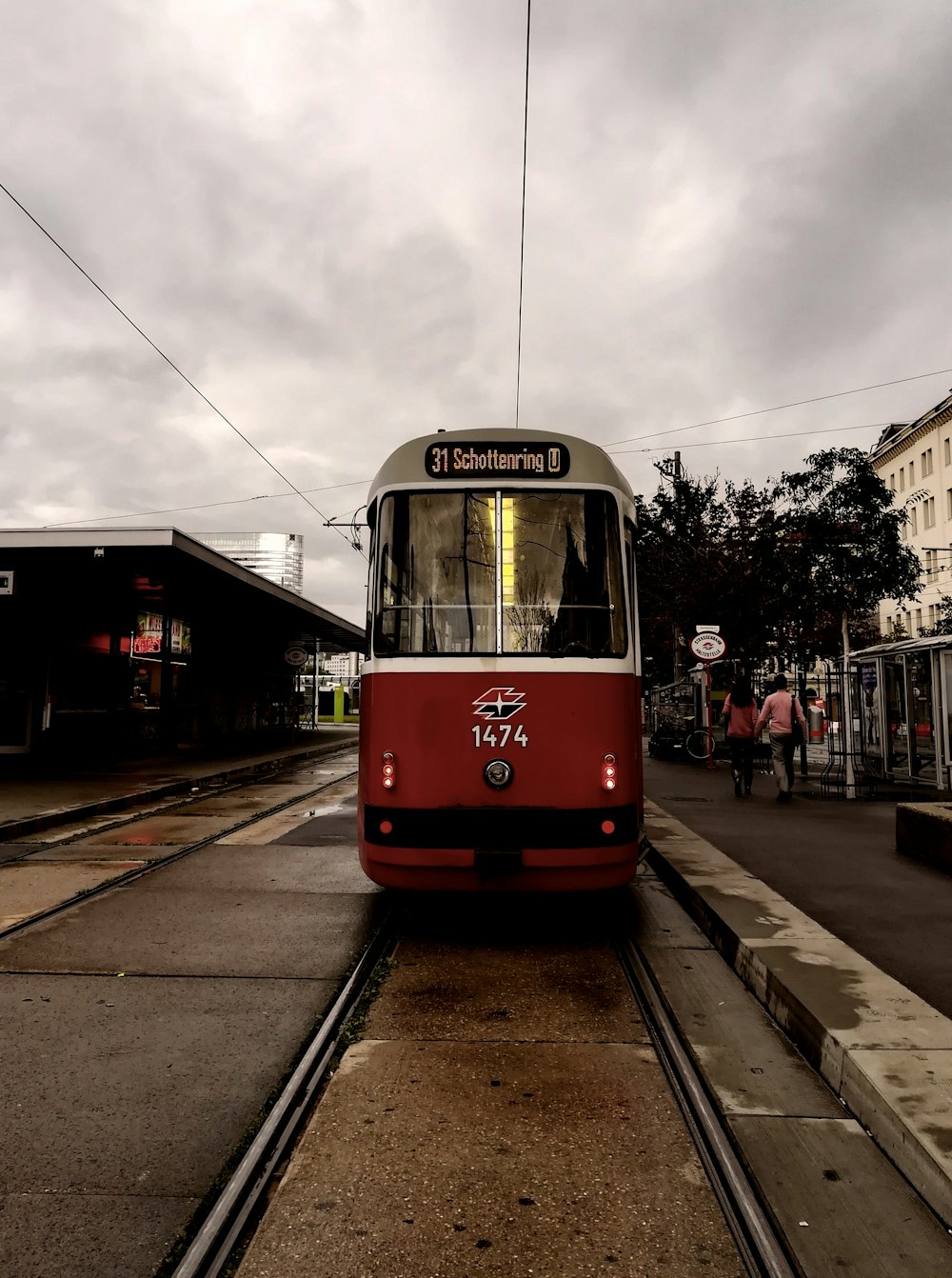 red and white tram on road during daytime