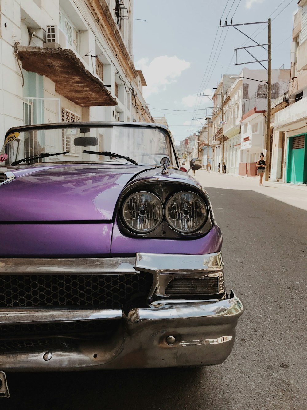 purple car parked on street during daytime