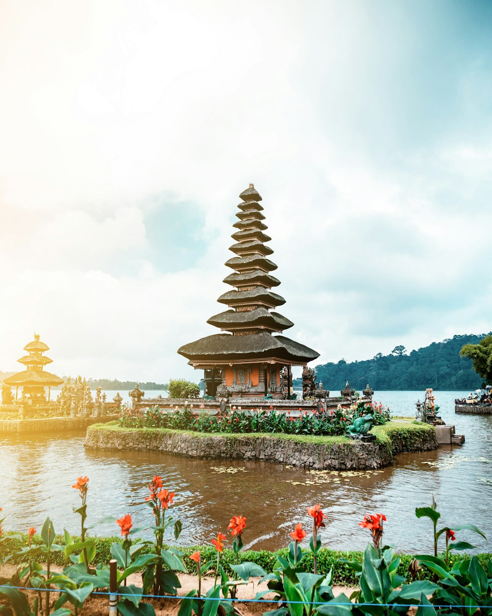 brown and white temple near body of water during daytime