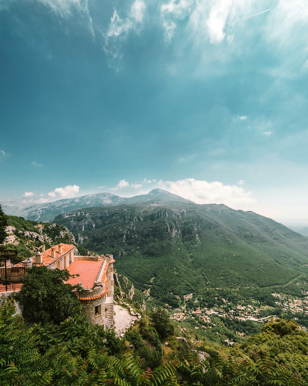 brown concrete building on top of mountain during daytime