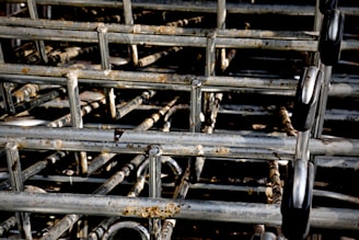 A stack of interlocking metal shopping carts with visible rust spots and signs of wear.