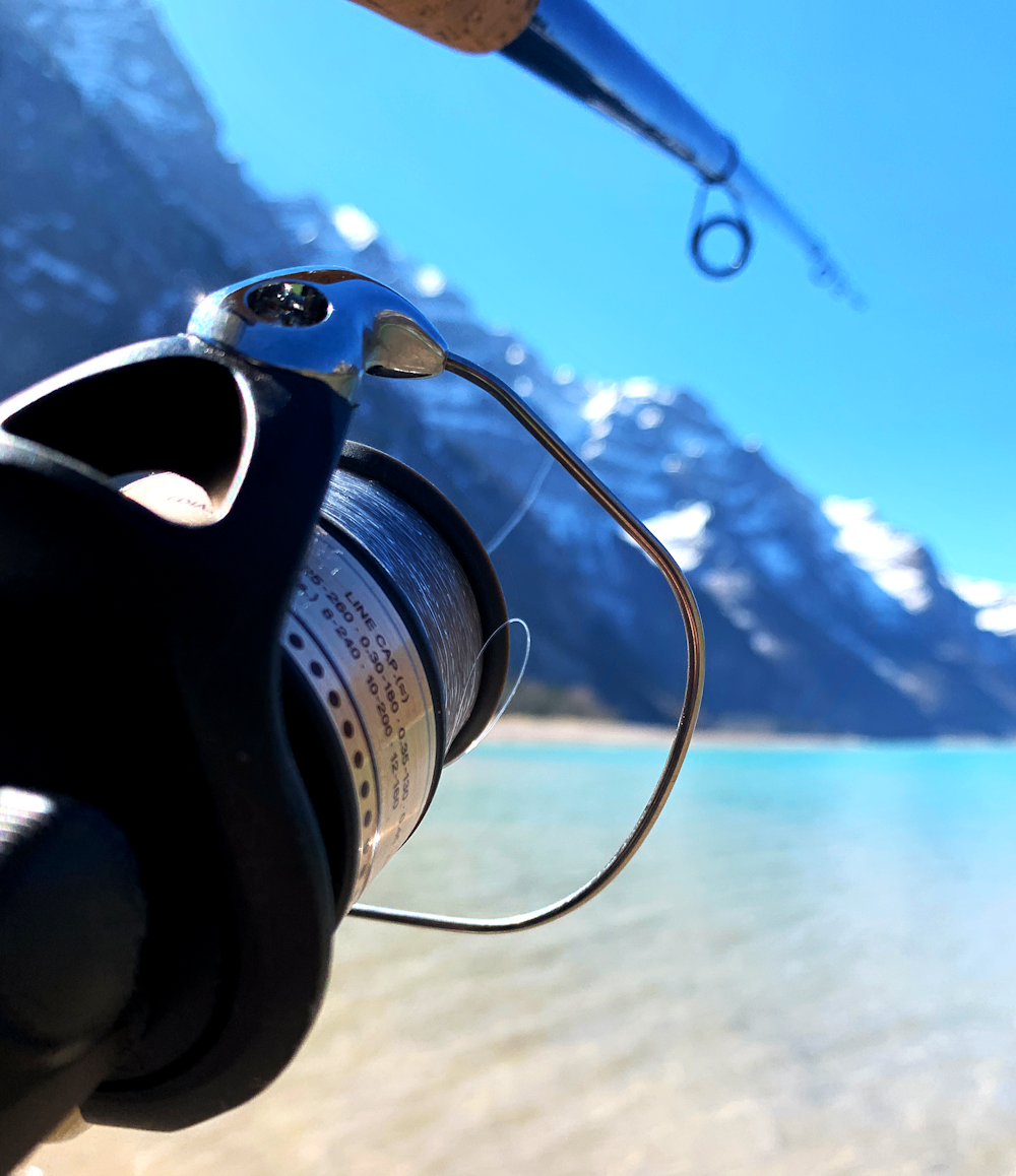 person holding black and silver fishing reel