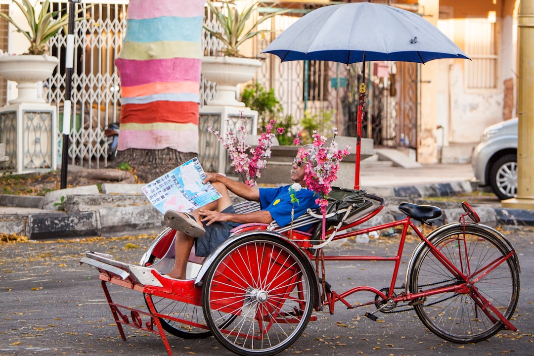 person in blue shirt sitting on red and blue wheelchair