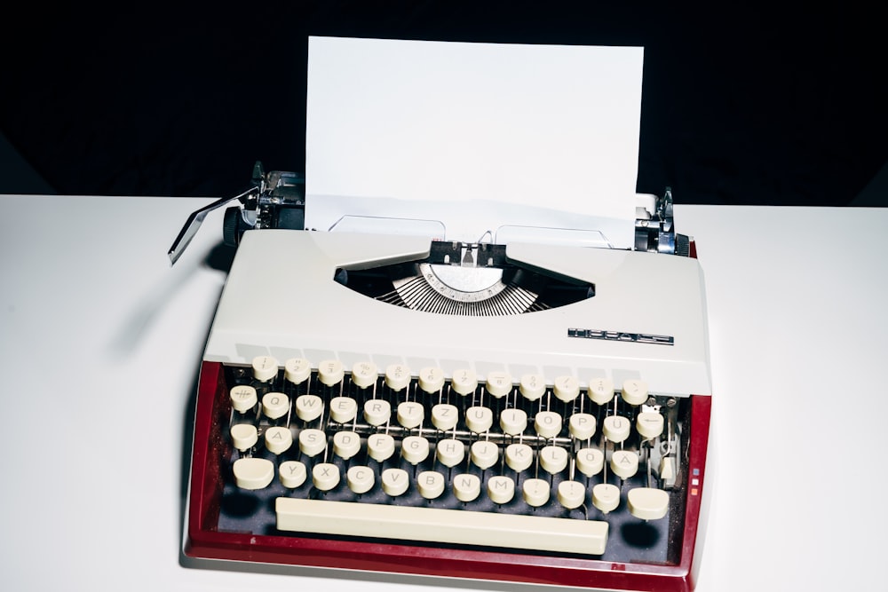 white and black typewriter on white table