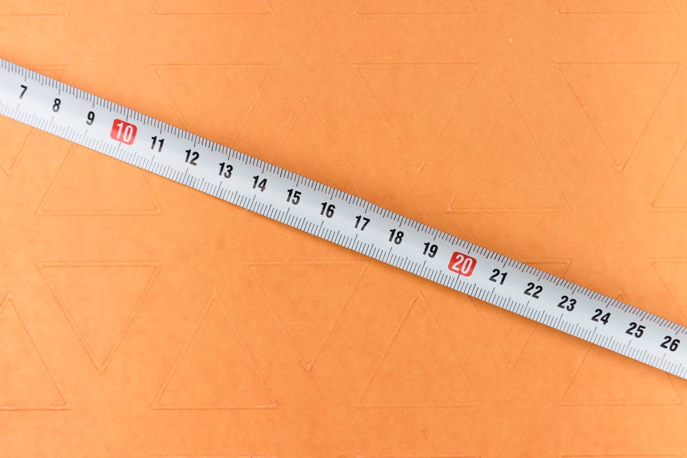 white and black ruler on brown surface