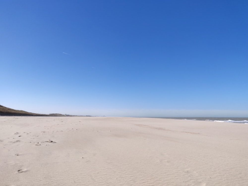 brown sand under blue sky during daytime