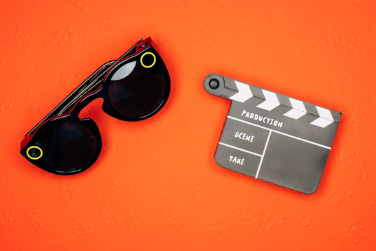 A film reel and clapperboard on a dark background