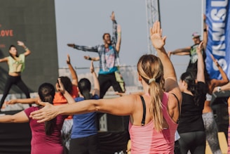 woman in pink tank top raising her hands