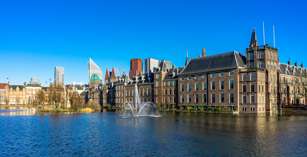 water fountain in the middle of city buildings during daytime