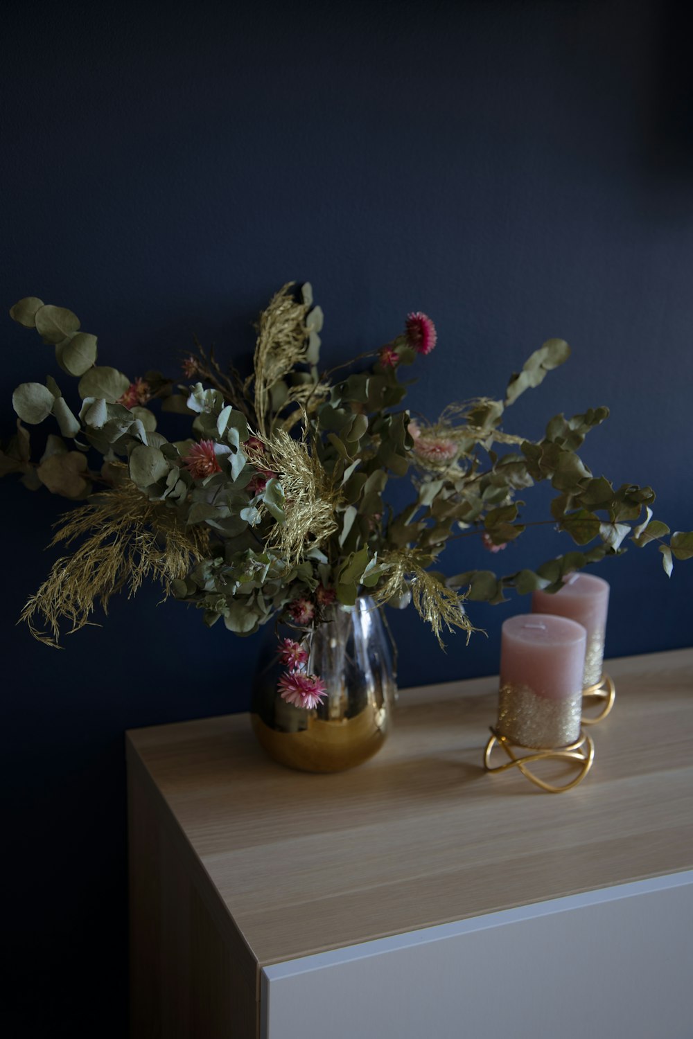 purple and white flowers in clear glass vase