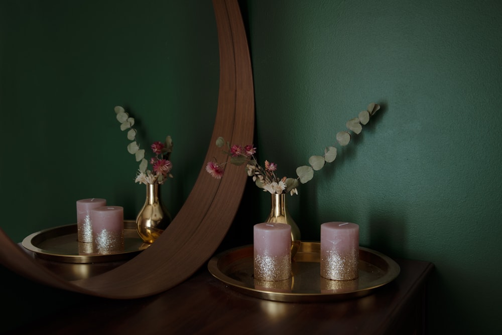 pink and white moth orchids in clear glass vase on brown wooden table